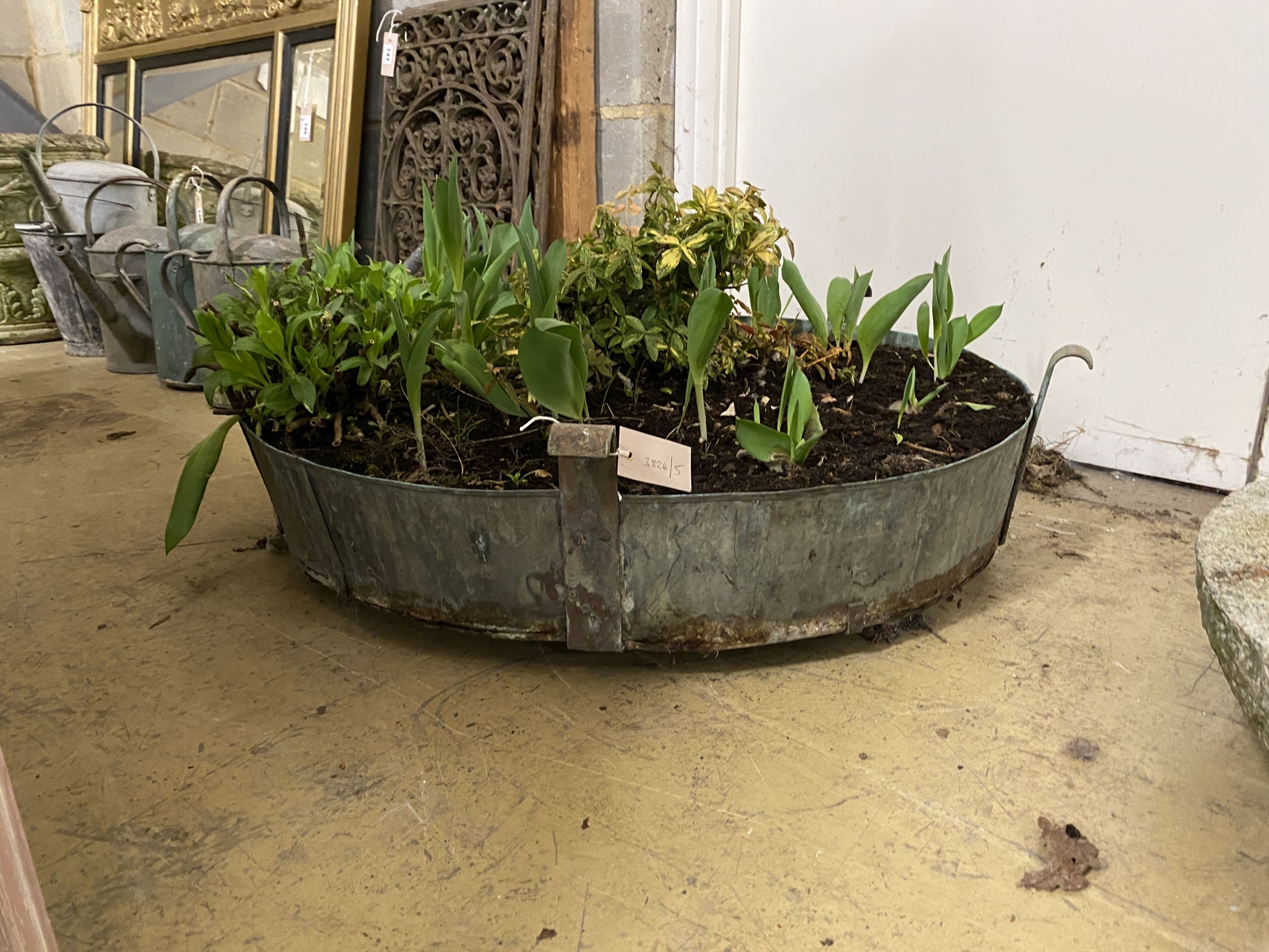 A circular galvanised metal garden planter, diameter 80cm